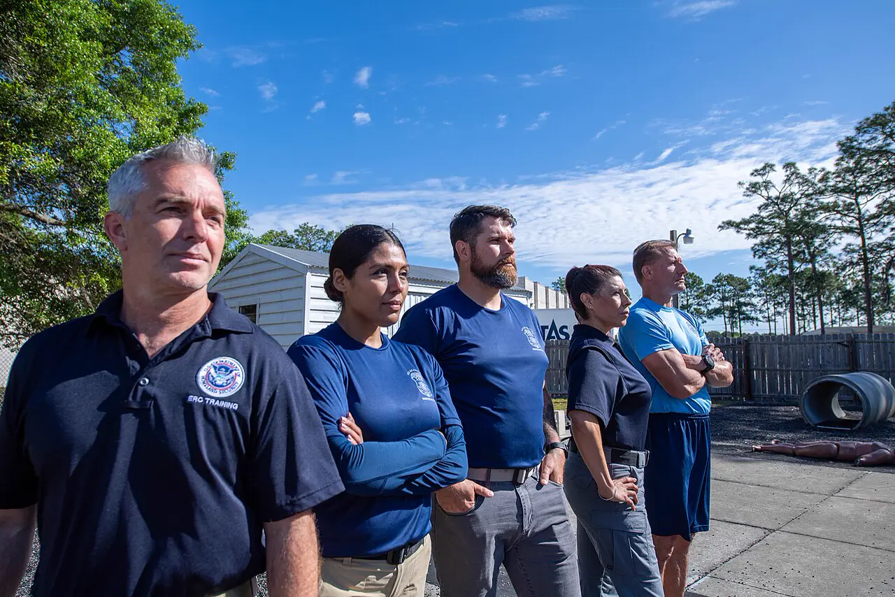 Staff of the US immigration agency ICE in uniform shirts